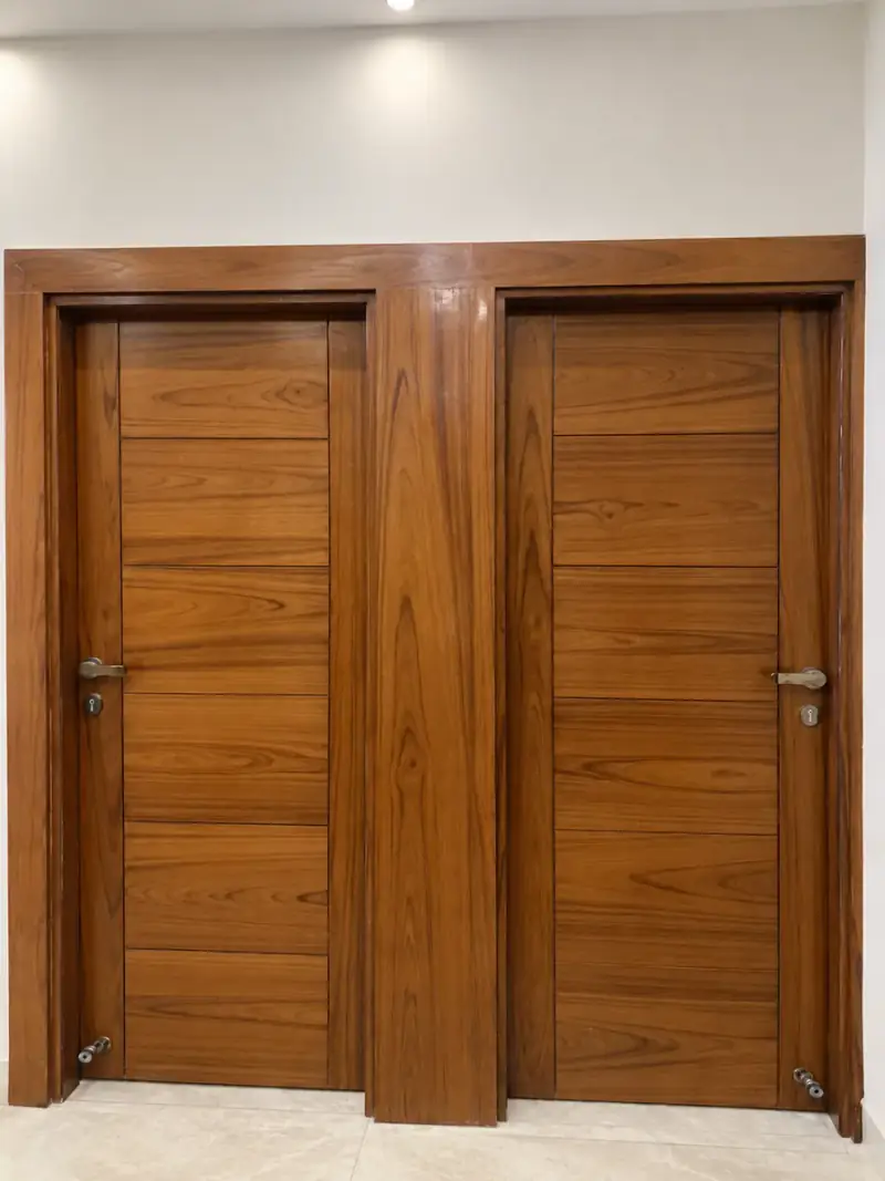 Polished teak double doors with a matching side panel and lever handles